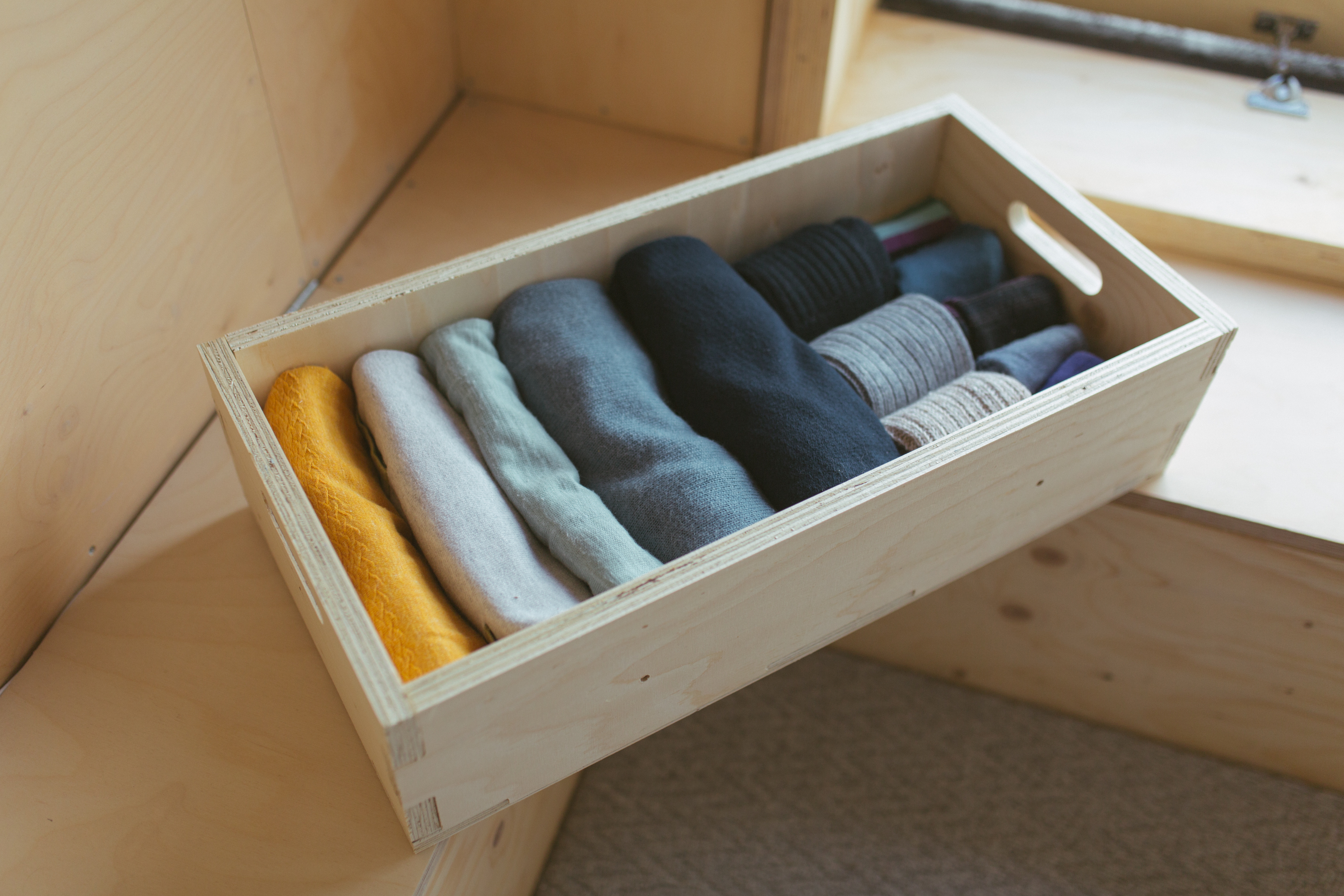 A U-Build box containing clothes, used as a drawer