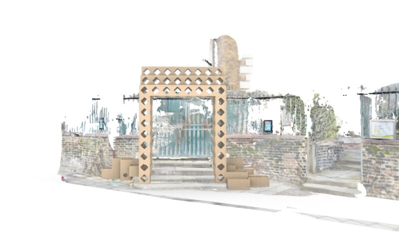The installation, titled Threshold of Change, features a wooden archway with diamond-shaped cut-outs standing on a pavement before a brick wall and gate. Steps lead up from the street on the right; the background is bright and faded.